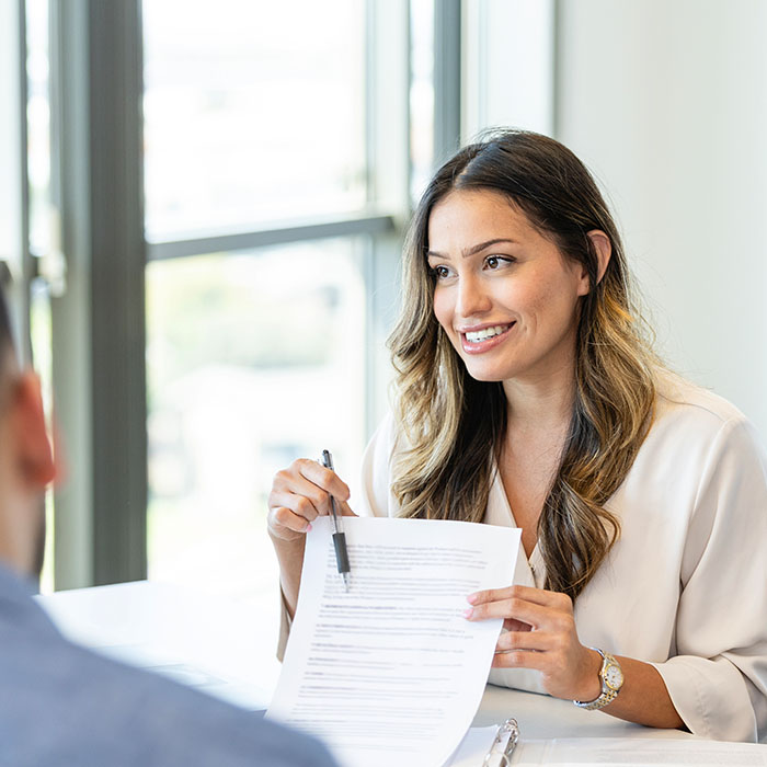 Confident loan officer reviewing mortgage document