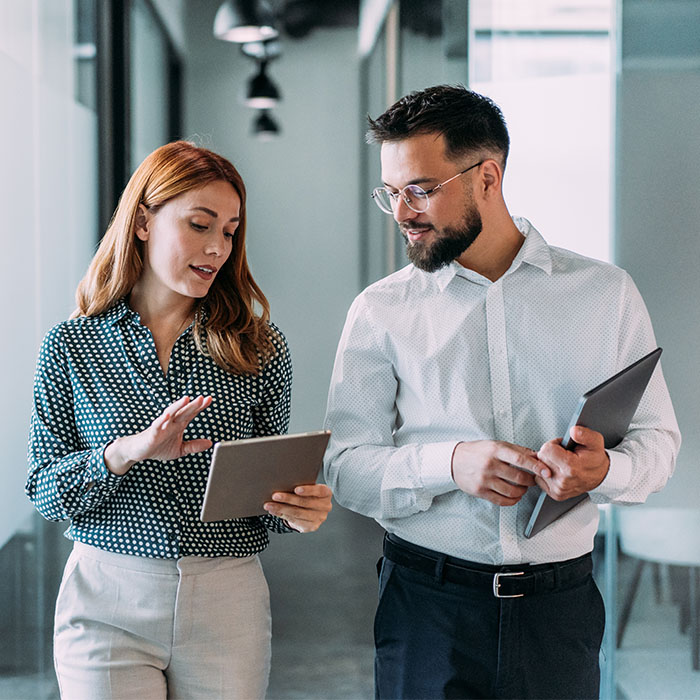 Two coworkers having a discussion in modern office