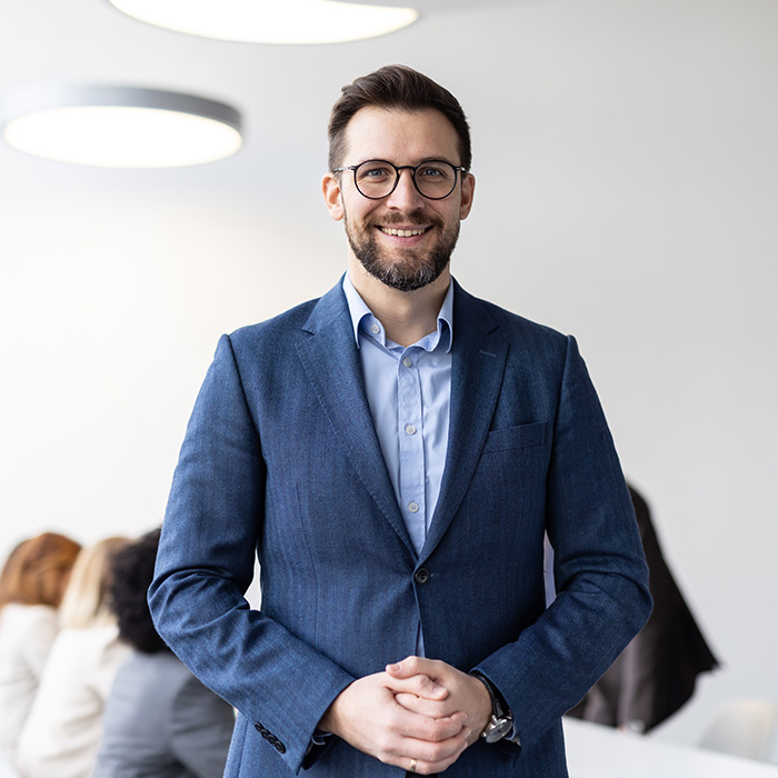 Confident businessman smiling in a modern office space